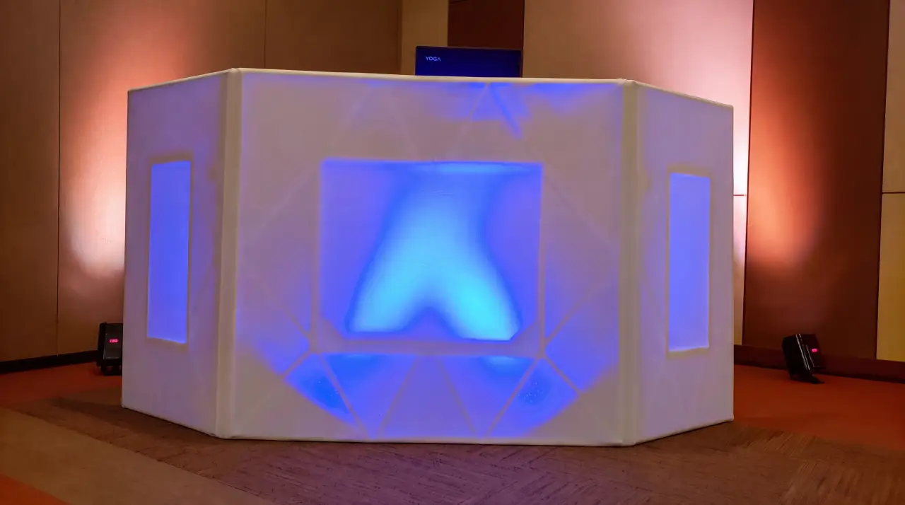 A professional corporate summit venue with a polished stage and precise modern lighting
